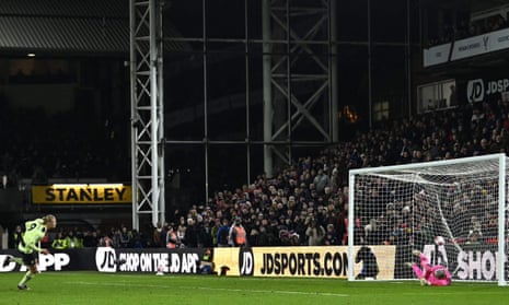 Manchester City’s Erling Haaland wheels away in celebration after scoring the opening goal from the penalty spot.