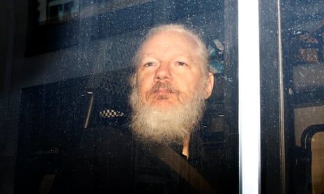 Julian Assange is seen in a police van after he was arrested by British police in London on 11 April.