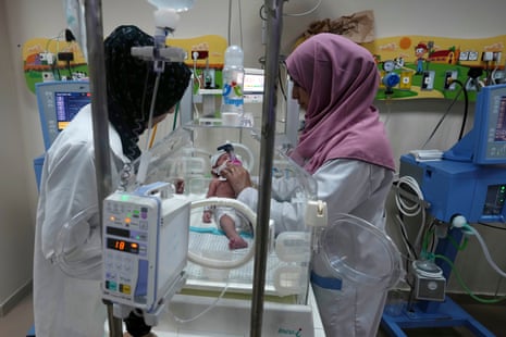 Israel-Hamas war live: White House promises ‘continued flow’ of Gaza aid as Israel steps up airstrikes in north of strip | Israel-Hamas war 9 Palestinian doctors treat a prematurely born baby at Al Aqsa Hospital in Deir el-Balah, Gaza Strip, on Sunday.