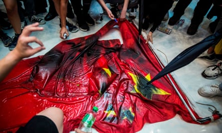 Protesters deface a Chinese flag at the New Town Plaza shopping mall in Hong Kong’s Sha Tin district