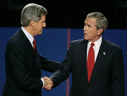 two men in suits shake hands