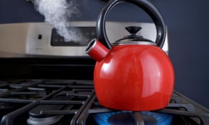 Red kettle boiling on a stove