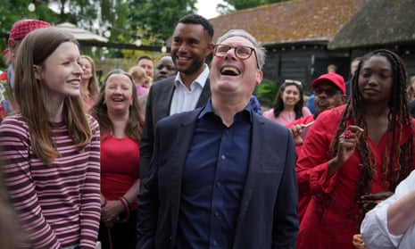 Britain’s Labour Party leader Keir Starmer laughs as he speaks to supporters poses after he spoke at an election campaign stop at a pub near Milton Keynes, England, Monday, 1 July 2024.