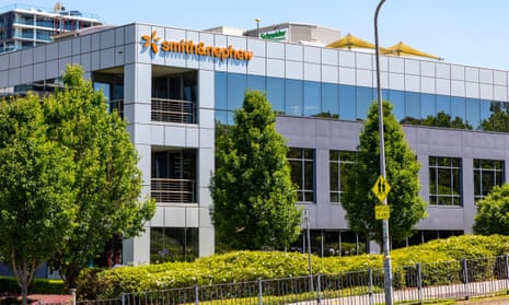 Smith & Nephew logo  on a building with trees in front of it