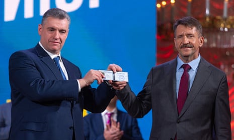 Leonid Slutsky, the leader of the Liberal Democratic Party (L) and Viktor Bout showing his membership card at a convention of the Liberal Democratic Party of Russia (LDPR) in Moscow.