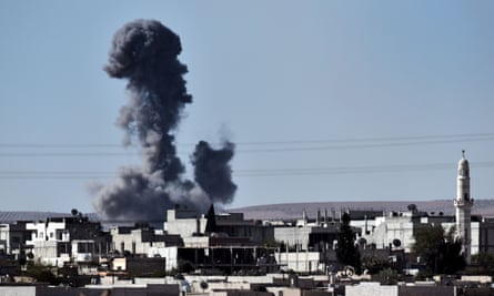 Smoke rises from the southwest of the Syrian town of Kobane following air strikes by the US-led coalition against positions held by Islamic State.