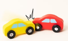 Two mini toy cars crashing.