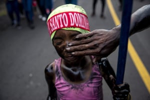 A young girl painted with black oil takes part in the procession in honour of Santo Domingo de Guzman in Managua