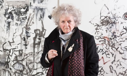 Maggi Hambling with cigarette in front of a painting