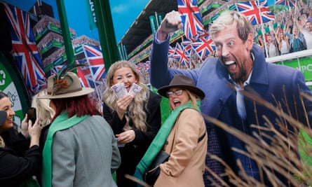 A racegoer celebrates after winning money in a Paddy Power shop at the Cheltenham Festival.