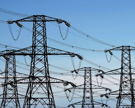 Electricity pylons against blue sky
