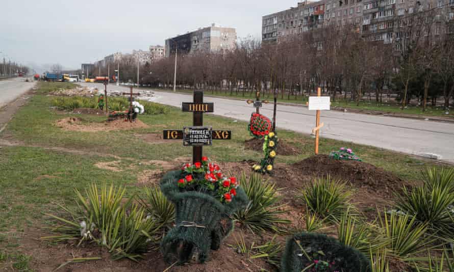 Graves of civilians killed next to apartment buildings in the southern port city of Mariupol, Ukraine April 10, 2022.