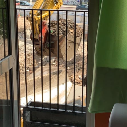 A digger works within metres of a resident’s living room at Coniston block, Camden
