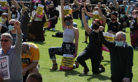 Protesters in George Square, Glasgow, kneel in support of the Black Lives Matter movement.