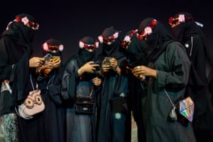 Tasneem Alsultan: A group of relatives busy on their social media phone apps at Al-Jenadriyah, a cultural festival in Riyadh, Saudi Arabia.