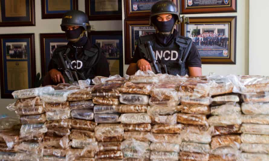 Dominican drug squad officers guard hundreds of kilos of cocaine seized in March 2013