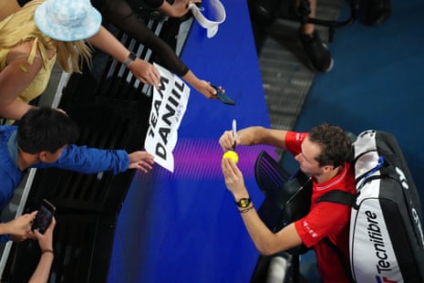 Daniil Medvedev signs his autograph for fans after winning his second round match against Australia's John Millman.
