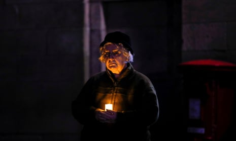 A woman holds a candle outside the Lichfield Cathedral, as part of a day of reflection.