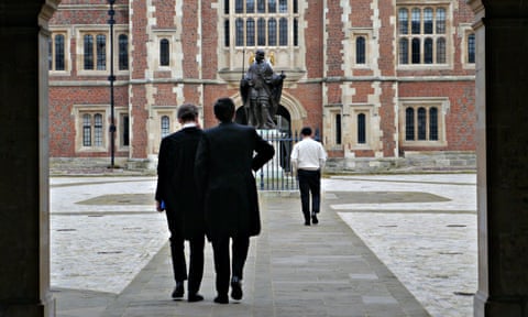 Pupils seen from behind walking into a courtyard at Eton college