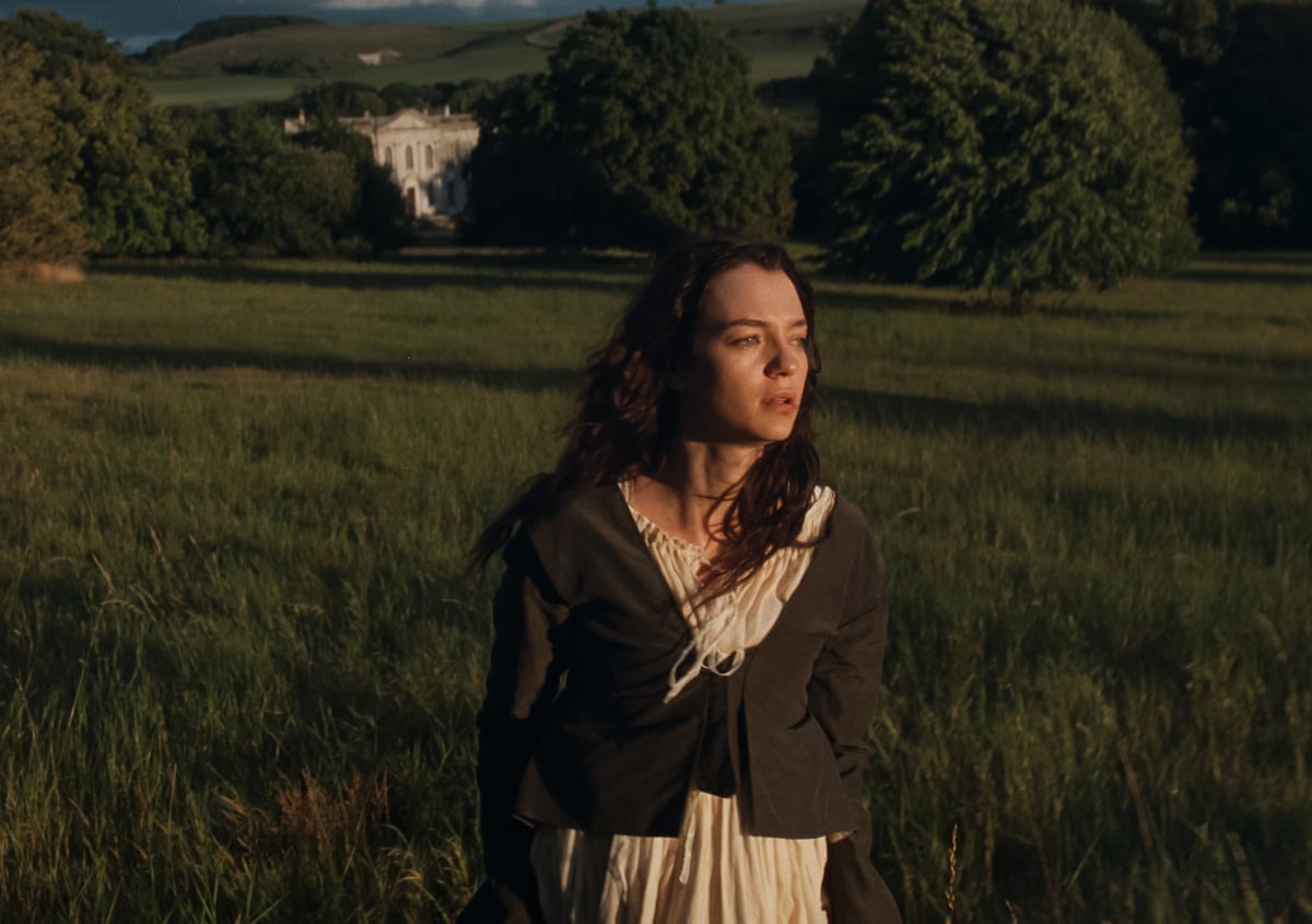 Woman standing in field gazing ahead