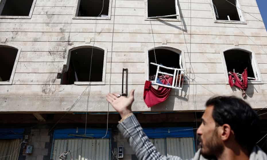 Yemen Sanaa Airstrikes - 11 Nov 2021<br>Mandatory Credit: Photo by Xinhua/REX/Shutterstock (12598913d) A local resident points at the broken windows of a building that was damaged during an airstrike in a neighborhood of Sanaa, Yemen, on Nov. 11, 2021. Warplanes of the Saudi-led coalition launched multiple airstrikes on military camps controlled by the Houthi militia in and around Yemen's capital Sanaa early Thursday morning, Houthi-run al-Masirah TV reported. Yemen Sanaa Airstrikes - 11 Nov 2021