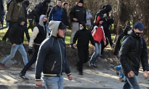 Far-right protesters carry stones to throw in protest against LGBT festival