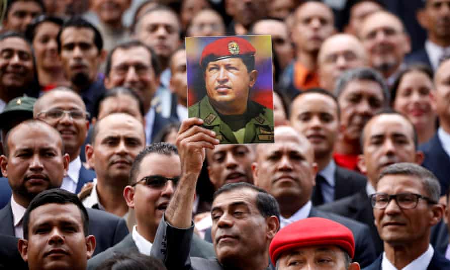 Members of the controversial new constituent assembly, criticized as a power grab, hold a picture of Venezuela’s late president Hugo Chávez.