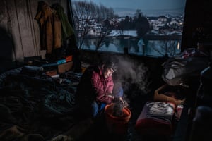 A young man from Pakistan washes clothes in his shelter near Bihać