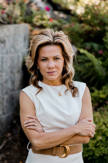 Woman looks straight ahead with arms crossed