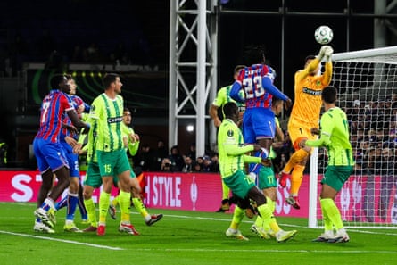 AEK Larnaca’s Zlatan Alomerovic punches the ball away from a Crystal Palace set piece.