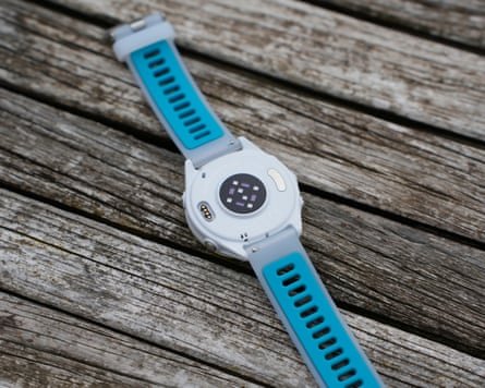 The back of the Garmin Forerunner 570 showing the heart rate sensor and charging port.