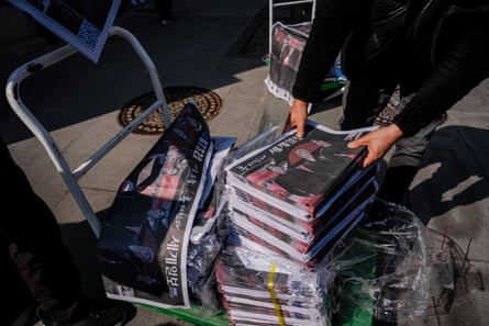 People give out special edition BTS commemorative newspapers in Seoul