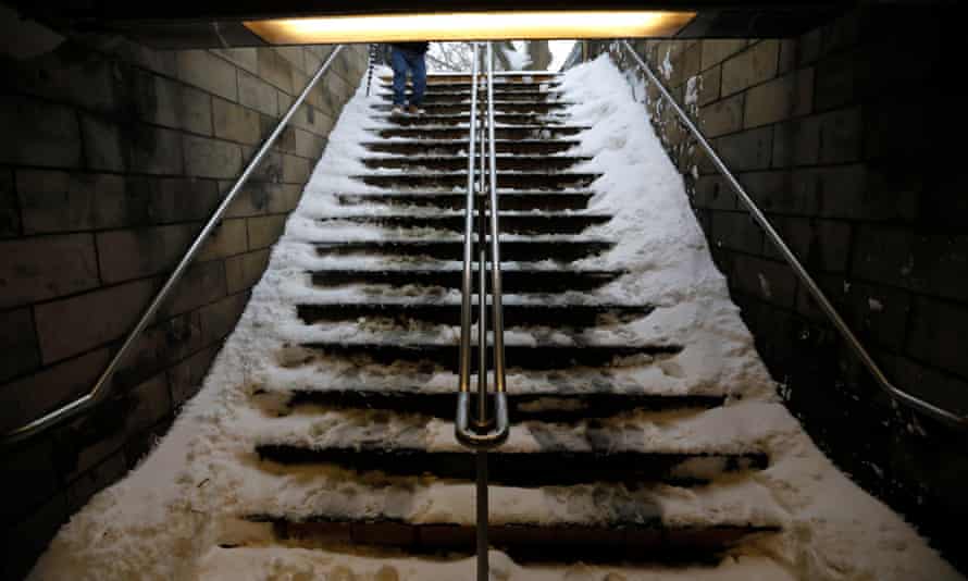 Snow-covered steps into a New York subway station