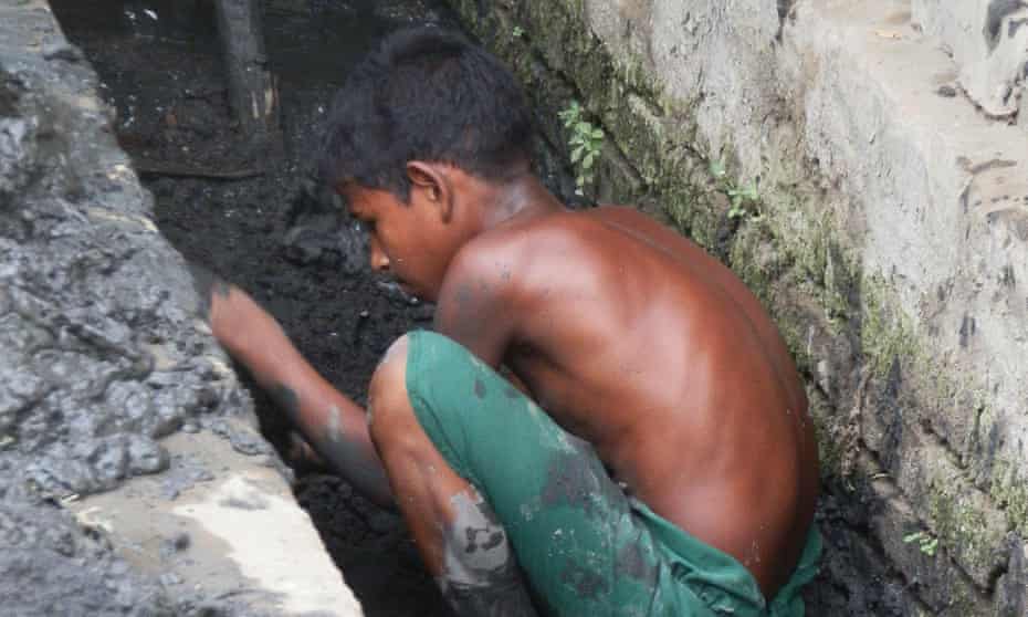 An 8-year old clears out the storm ditch ahead of the Monsoon season, in the Aung Ming Lar ghetto of Sittwe.