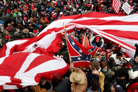 Protesters wave American and Confederate flags during clashes with Capitol police on 6 January 2021.