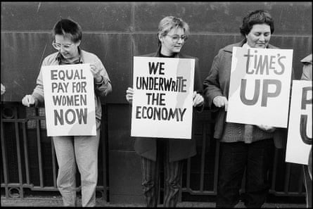 Women hold up banners