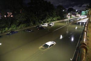 Vehicles are submerged on a waterlogged road in New York