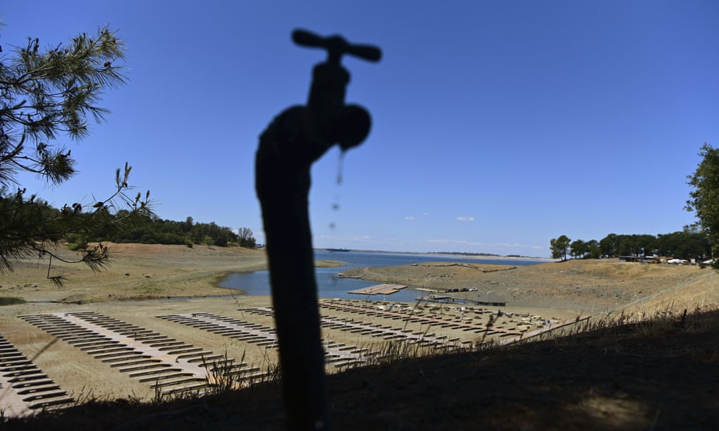 Water drips from a faucet near boat docks sitting on dry land at the drought-stricken Folsom Lake last month.