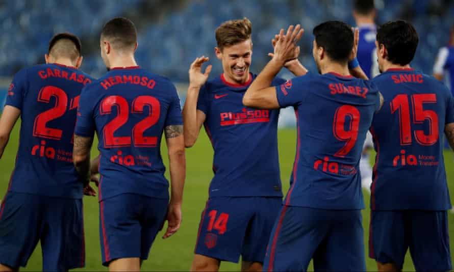 Atlético Madrid’s Marcos Llorente (centre) celebrates with Luis Suárez after scoring the second goal.