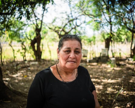 A woman outside with a leafy backdrop