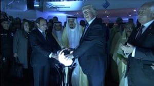 Donald Trump places his hands on a glowing orb as he tours the Global Center for Combatting Extremist Ideology in Riyadh, Saudi Arabia.