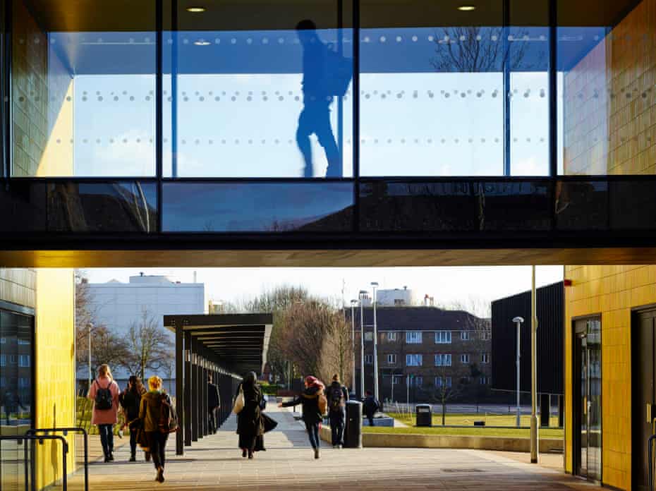 pupils exit burntwood school  as one pupil walks along a glass-sided walkway above
