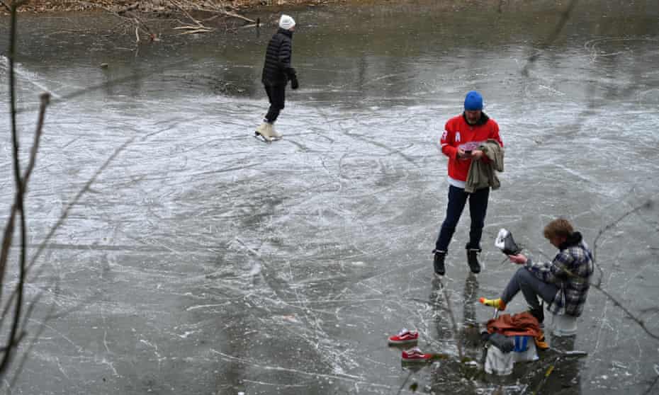 People skate on a canal as a winter storm approaches Washington DC, on Sunday.