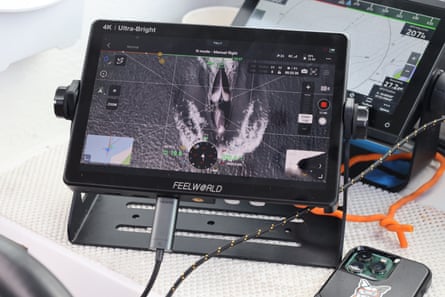 Aerial shot of an orca’s blowhole shown on a drone monitor.