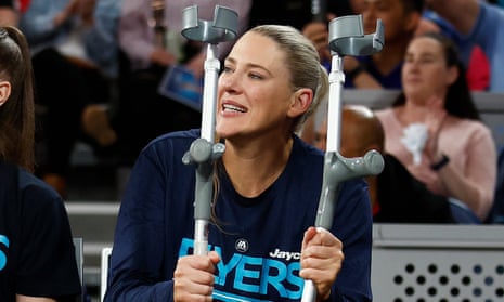 Basketball legend Lauren Jackson holds back tears as she supports teammates after her Achilles injury.
