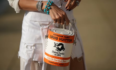 An orange Louis Vuitton bag shaped as a paint can, with words on it including ‘Exterior paint: Louis Vuitton’