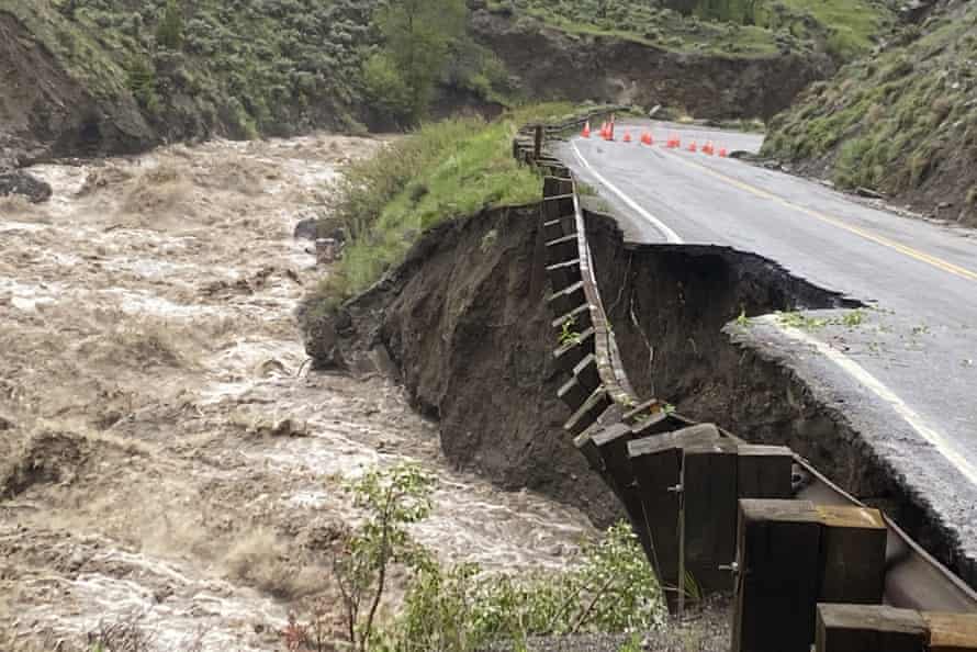 A swollen river has taken out a chunk of road.