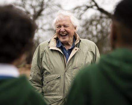 David Attenborough laughing as children look on