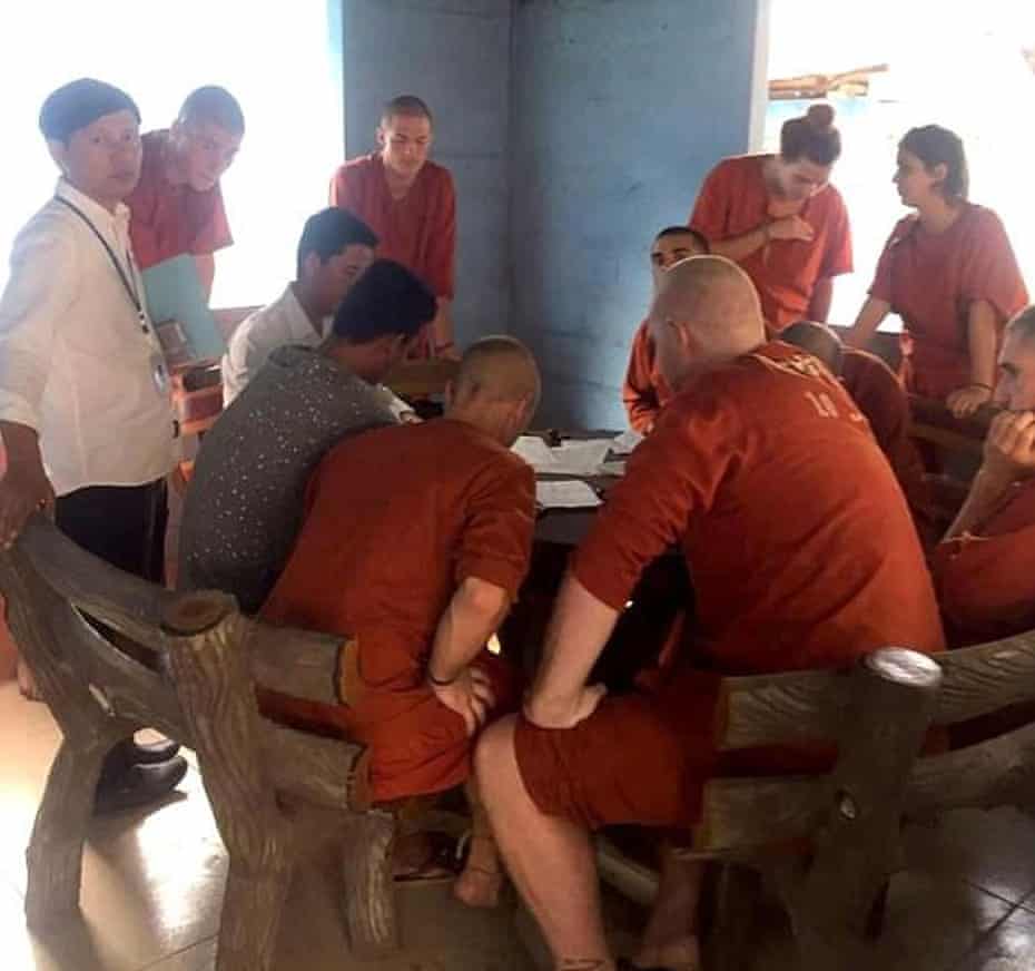 A group of foreigners including five Britons are seen in jumpsuits with their heads shaved while being held on remand at a prison in Siem Reap.
