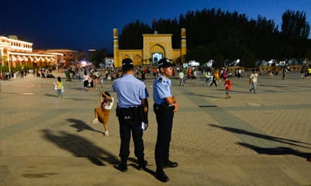 Police stand guard at the main square in Kashgar, Xinjiang.
